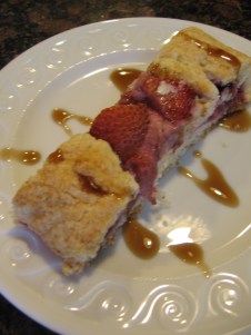 Slice of strawberry roll with sauce