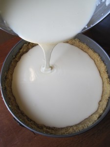 Filling the crust with the cheesecake filling