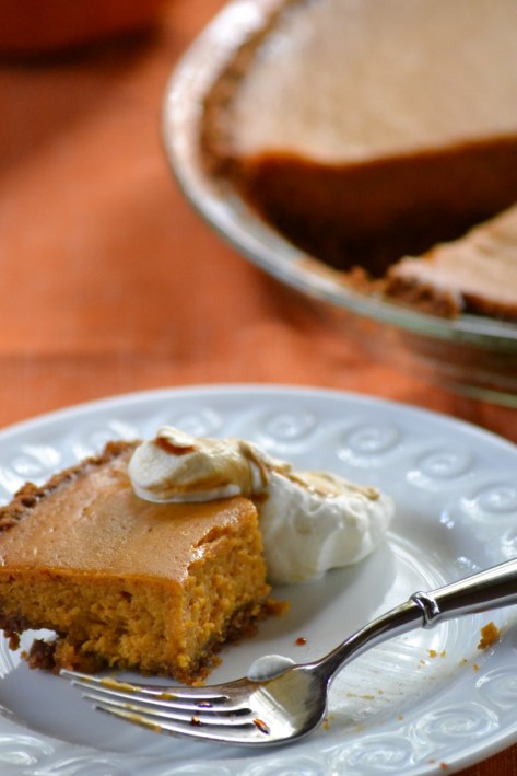 Slice of Pumpkin Pie with Gingersnap Crust and Molasses Whipped Cream